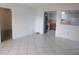 Open-concept living room flowing into a bright kitchen with a modern washer/dryer stack at 8132 Fairways Cir # R103, Ocala, FL 34472
