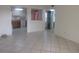 Open living space with tile floors, views of the kitchen, and access to the front door at 8132 Fairways Cir # R103, Ocala, FL 34472