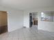 Spacious living room with neutral tile flooring and a view to the kitchen at 8132 Fairways Cir # R103, Ocala, FL 34472
