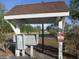 Community mailboxes under a sheltered area with a 'No Loitering' sign at 8132 Fairways Cir # R103, Ocala, FL 34472