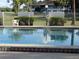 Inviting community pool with fencing, landscaping, and lounge chairs in the background at 8132 Fairways Cir # R103, Ocala, FL 34472
