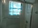 Bright shower-tub combo featuring a glass door and updated fixtures at 8132 Fairways Cir # R103, Ocala, FL 34472