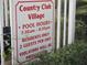 Sign displays 'Country Club Village' information including pool hours for residents at 8132 Fairways Cir # R103, Ocala, FL 34472