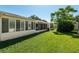 An expansive green lawn features a covered and screened in patio with ample shade at 8625 Sw 94Th Ln # D, Ocala, FL 34481