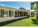 View of the home's backyard with a screened in patio at 8625 Sw 94Th Ln # D, Ocala, FL 34481