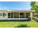 Backyard view featuring a patio, lawn, and shady trees at 8625 Sw 94Th Ln # D, Ocala, FL 34481