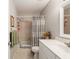 Bathroom with shower and tub combination, gray vanity, and soft beige-colored tile flooring at 8625 Sw 94Th Ln # D, Ocala, FL 34481