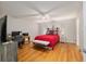 Comfortable bedroom with ceiling fan, wood floors, and decorative headboard at 8625 Sw 94Th Ln # D, Ocala, FL 34481