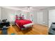 Bright bedroom featuring wood floors, a ceiling fan, and ample natural light at 8625 Sw 94Th Ln # D, Ocala, FL 34481