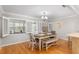 Bright dining area with shuttered windows, wood floors, and a cozy dining set for comfortable Gathering meals at 8625 Sw 94Th Ln # D, Ocala, FL 34481