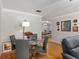 Cozy dining area with hardwood floors, a round glass table, and seating for four, perfect for intimate meals at 8625 Sw 94Th Ln # D, Ocala, FL 34481