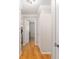 Hallway featuring wood floors, white doors, and access to multiple rooms in the home at 8625 Sw 94Th Ln # D, Ocala, FL 34481