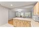 Bright eat-in kitchen featuring light wood cabinets, an island, and views to the dining area with wood floors at 8625 Sw 94Th Ln # D, Ocala, FL 34481