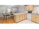 Open kitchen and breakfast area features wooden cabinets, a dining table and breakfast bench at 8625 Sw 94Th Ln # D, Ocala, FL 34481
