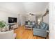 Bright living room featuring hardwood floors, comfortable blue sofas, and stylish furnishings, creating a cozy atmosphere at 8625 Sw 94Th Ln # D, Ocala, FL 34481