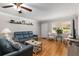Open-concept living room showcases hardwood floors, a ceiling fan, and comfortable seating, perfect for relaxation at 8625 Sw 94Th Ln # D, Ocala, FL 34481