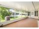 Enclosed patio featuring a red floor, and a back door to the yard for relaxing or entertaining at 8625 Sw 94Th Ln # D, Ocala, FL 34481
