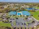 An aerial view of community pool, parking, and amenities surrounded by lush landscaping and trees at 8750 Sw 108Th St, Ocala, FL 34481