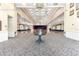 Elegant ballroom with chandeliers, stage, neutral walls, and patterned carpeting at 8750 Sw 108Th St, Ocala, FL 34481