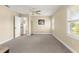 Spacious bedroom features a ceiling fan, window with shutters, and a plush, comfortable carpet at 8750 Sw 108Th St, Ocala, FL 34481