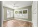 Bright bedroom with plantation shutters on windows, light green walls, and wood laminate flooring at 8750 Sw 108Th St, Ocala, FL 34481