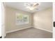 Comfortable bedroom with large window and shutters, with plush carpet for a cozy ambiance at 8750 Sw 108Th St, Ocala, FL 34481