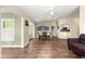 Open-concept dining area featuring wood floors, ample natural light, and views into other living spaces at 8750 Sw 108Th St, Ocala, FL 34481