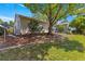 Exterior shot of a home featuring mature trees, green lawn, and well-maintained landscaping at 8750 Sw 108Th St, Ocala, FL 34481