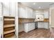 Bright kitchen with white cabinets, granite countertops, stainless steel appliances, and pull out shelving at 8750 Sw 108Th St, Ocala, FL 34481