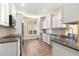 Updated kitchen with white cabinets, granite countertops, and stainless-steel appliances at 8750 Sw 108Th St, Ocala, FL 34481