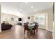 Open-concept living space with dining area, wood floors, and plenty of natural light from the windows at 8750 Sw 108Th St, Ocala, FL 34481