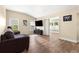 A stylish living room with wood floors, modern furniture, and bright natural light from large windows at 8750 Sw 108Th St, Ocala, FL 34481