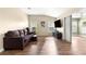 Cozy living room with wood-look floors, a comfortable sofa, and abundant natural light from the windows at 8750 Sw 108Th St, Ocala, FL 34481