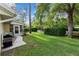 Well-maintained backyard featuring lush green grass, mature trees, and a patio area perfect for relaxing at 8833 Sw 98Th Street Rd # E, Ocala, FL 34481
