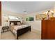 Bright bedroom with large windows and ceiling fan overlooking the lush outdoors at 8833 Sw 98Th Street Rd # E, Ocala, FL 34481
