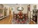 Charming dining room featuring a wood table and a decorative rug under an oval mirror at 8833 Sw 98Th Street Rd # E, Ocala, FL 34481