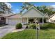 Charming home with a manicured front yard, inviting porch, and attached garage provides curb appeal at 8833 Sw 98Th Street Rd # E, Ocala, FL 34481