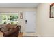 Bright foyer with hardwood floors and view of the living room at 8833 Sw 98Th Street Rd # E, Ocala, FL 34481