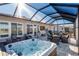 Backyard featuring a hot tub, ample seating and patio space, and outdoor dining area at 8878 Sw 103Rd Cir, Ocala, FL 34481