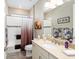 Well-lit bathroom with a shower and a vanity with a sink at 8878 Sw 103Rd Cir, Ocala, FL 34481
