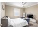 Bright bedroom with ceiling fan, window with blinds, plush carpet and neutral walls at 8878 Sw 103Rd Cir, Ocala, FL 34481
