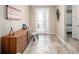 Inviting entryway with stylish decor, wood floors, and decorative front door at 8878 Sw 103Rd Cir, Ocala, FL 34481