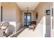 Charming front porch with comfortable seating, creating a welcoming entrance with tasteful decor and relaxing ambiance at 8878 Sw 103Rd Cir, Ocala, FL 34481