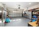 Spacious garage with metal storage cabinets, open door and ample storage, plus a refrigerator for convenience at 8878 Sw 103Rd Cir, Ocala, FL 34481