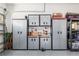 Organized garage space with metal storage cabinets, a workbench, and a variety of tools and supplies at 8878 Sw 103Rd Cir, Ocala, FL 34481