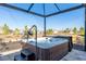 Inviting hot tub on a screened-in patio, offering a private and relaxing outdoor space with serene backyard views at 8878 Sw 103Rd Cir, Ocala, FL 34481