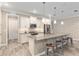 Modern kitchen featuring white cabinets, stainless steel appliances, granite countertops, and a stylish island with seating at 8878 Sw 103Rd Cir, Ocala, FL 34481