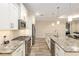 Well-equipped kitchen featuring stainless steel appliances, white cabinetry, granite countertops, and a stylish backsplash at 8878 Sw 103Rd Cir, Ocala, FL 34481