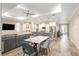 Bright open-concept area with a dining table, gray couch and access to the outside patio through sliding glass doors at 8878 Sw 103Rd Cir, Ocala, FL 34481