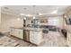 Open-concept living space featuring a kitchen island, neutral decor, and ample natural light at 8878 Sw 103Rd Cir, Ocala, FL 34481